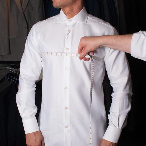 man being measured with tape measure across chest