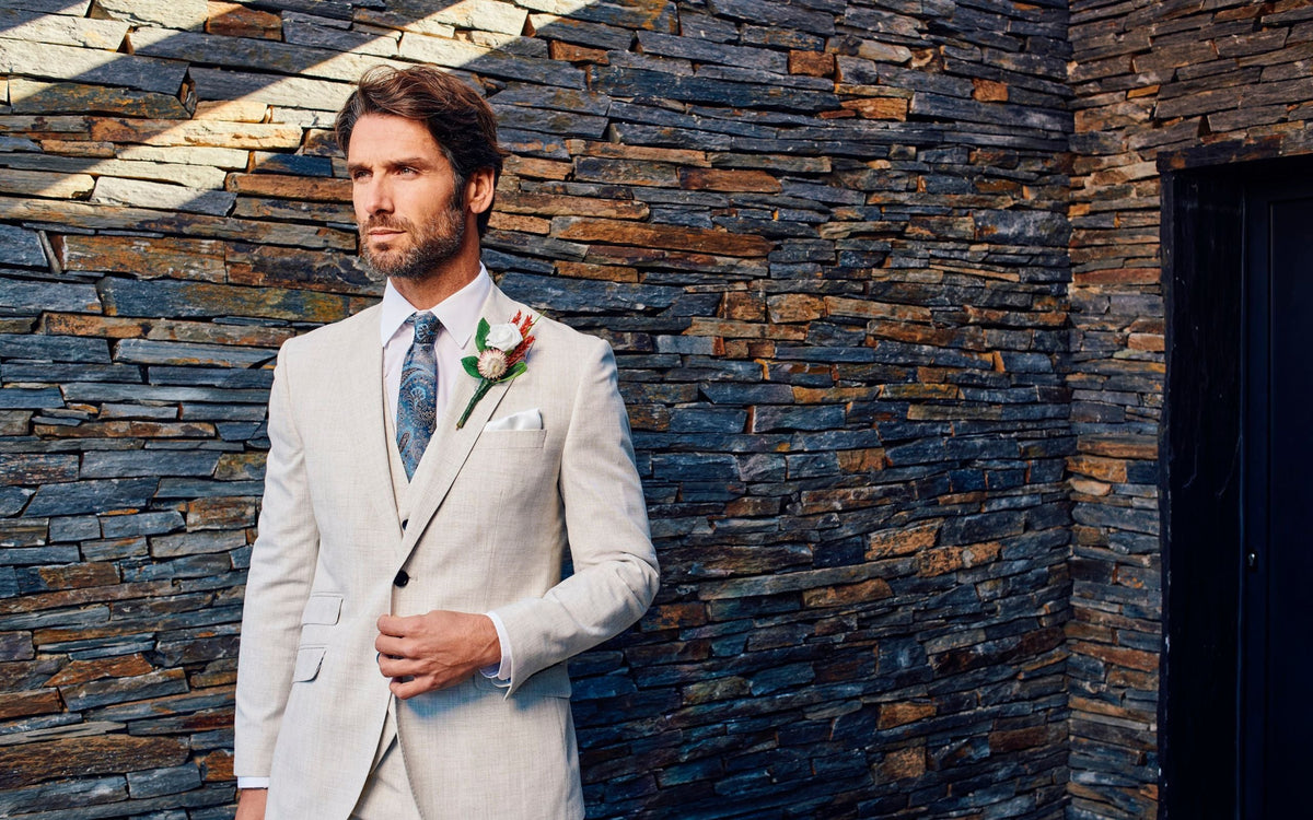 man wearing ivory wedding suit