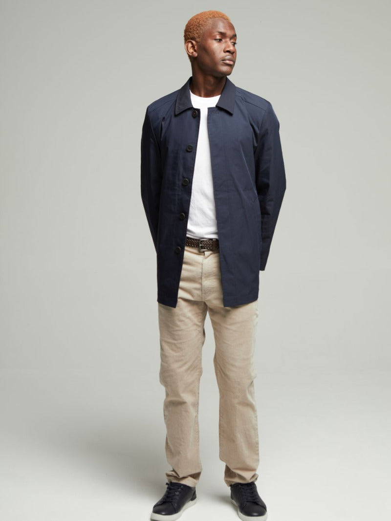 Full-length view of the Navy Wentworth Travel Raincoat worn open on a model