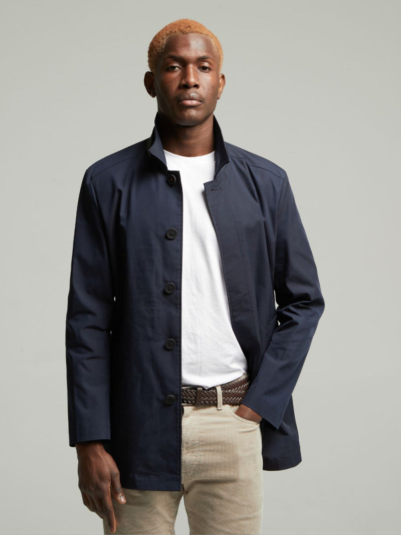 Guards London Wentworth Travel Raincoat in Navy, worn open over a white T-shirt, front view