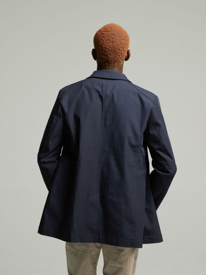Back view of the Navy Wentworth Travel Raincoat worn on a model