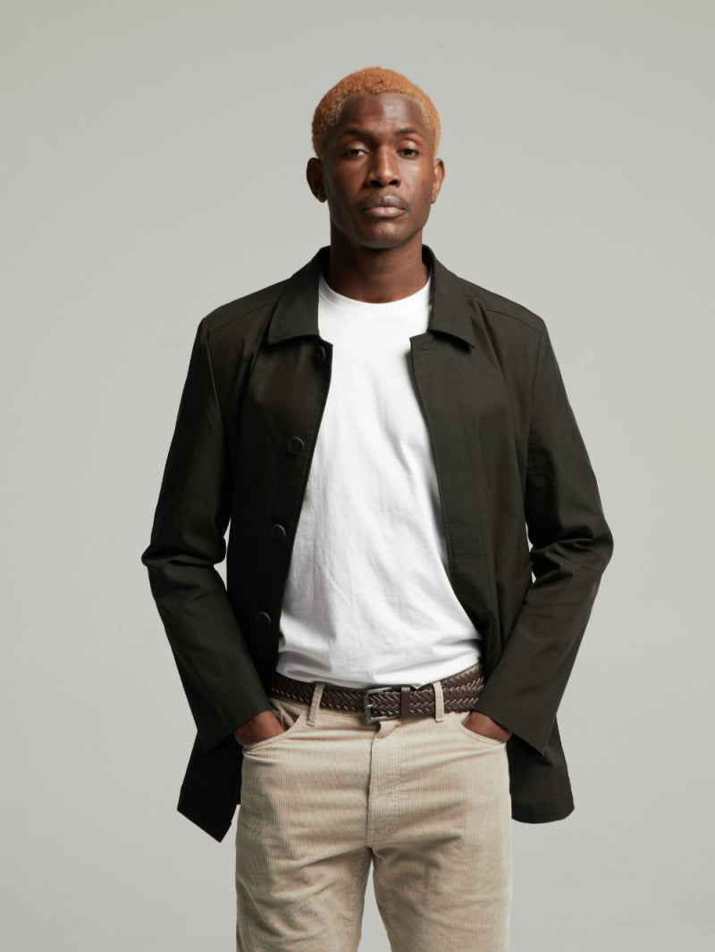 Black Wentworth Travel Raincoat worn open over a white T-shirt, front view