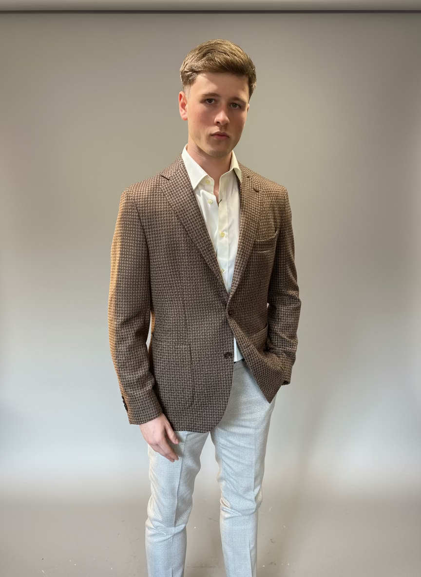 Man wearing a brown blazer and white shirt in a clothing store.