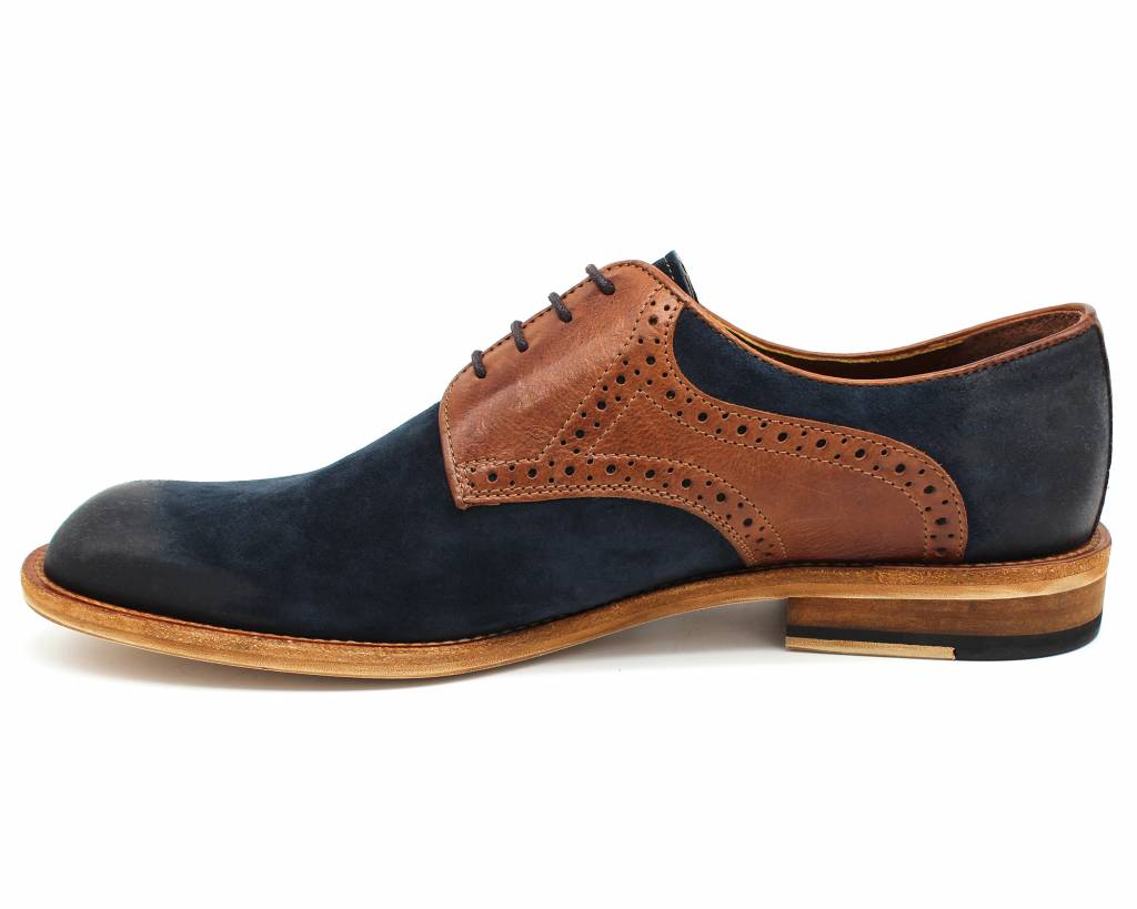 Navy and brown derby shoe, inside profile showing the brogue punching and stacked heel