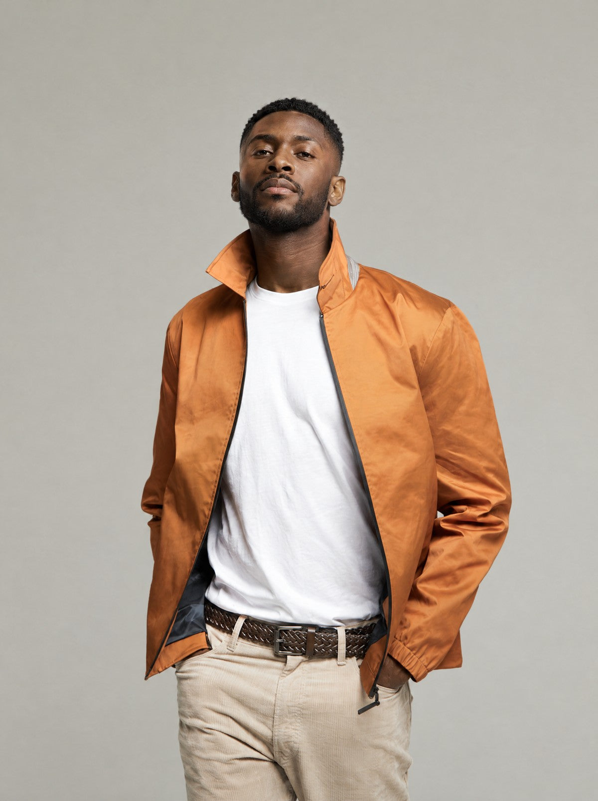 Tan Martelloz zip coach jacket worn open, hand in pocket