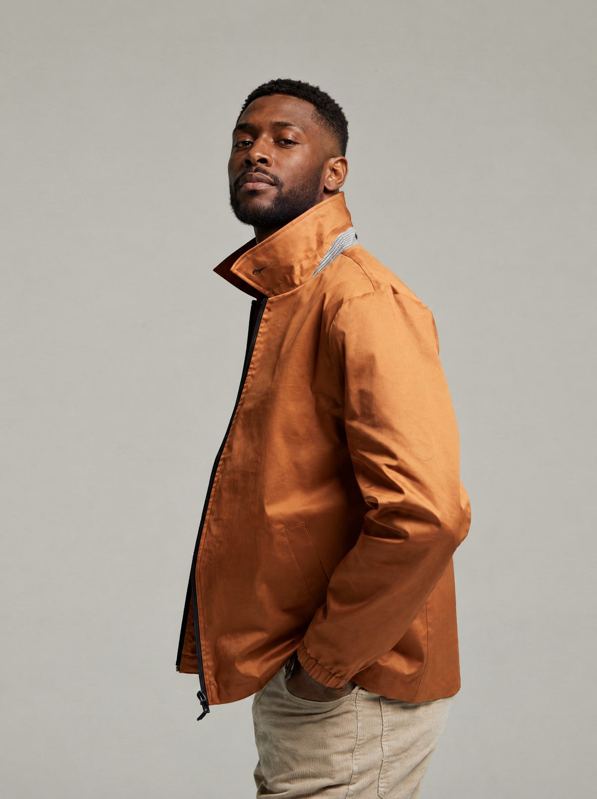 Side view of the Tan Martelloz coach jacket with the collar turned up