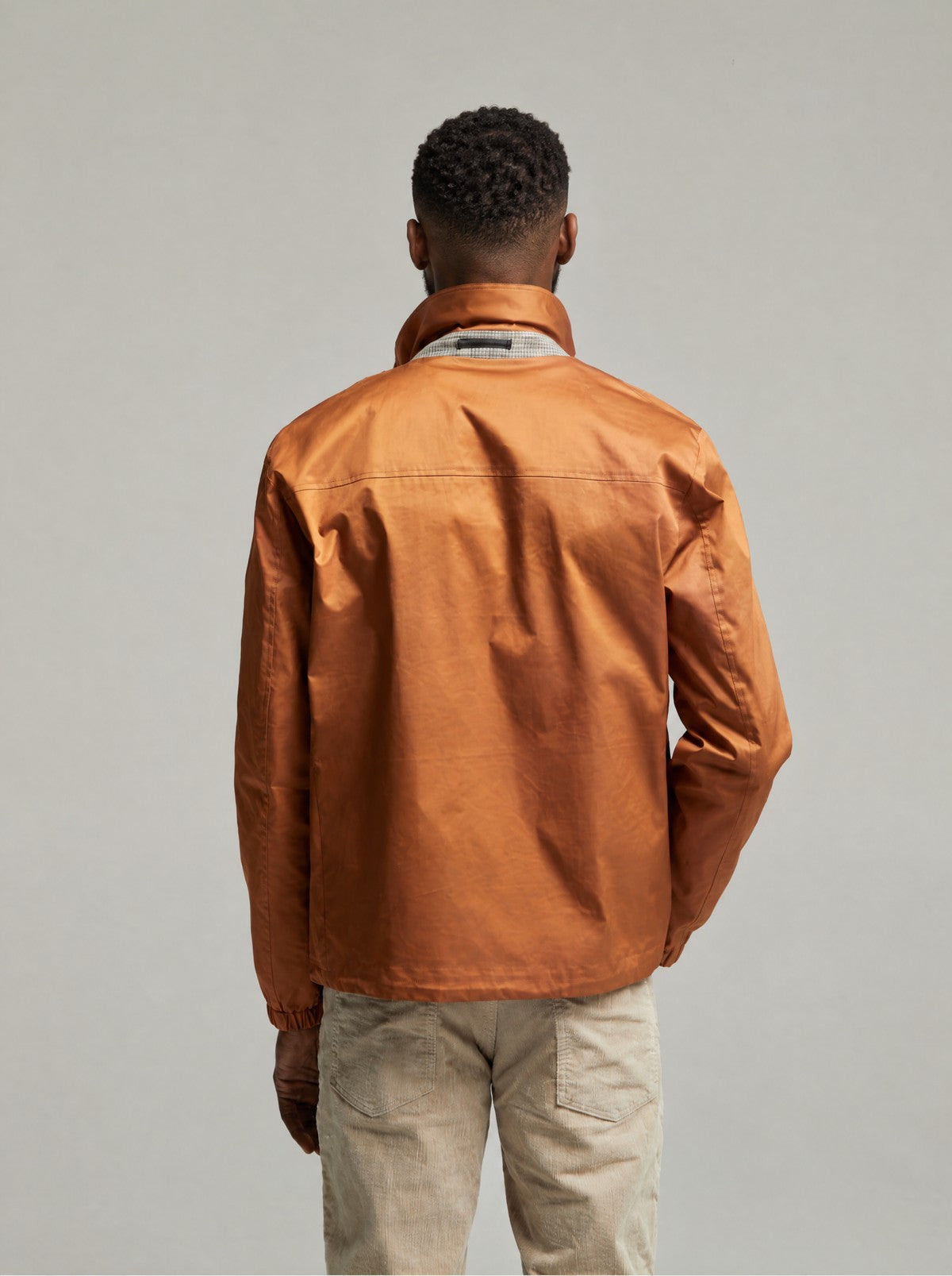 Back view of the Tan Martelloz zip coach jacket on a model