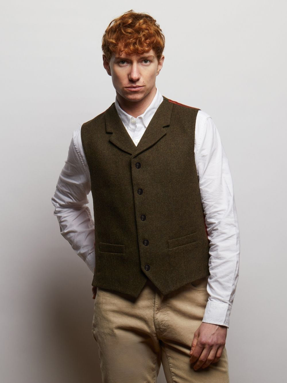Sherwood tweed waistcoat in Dark Green Herringbone, worn over a white shirt