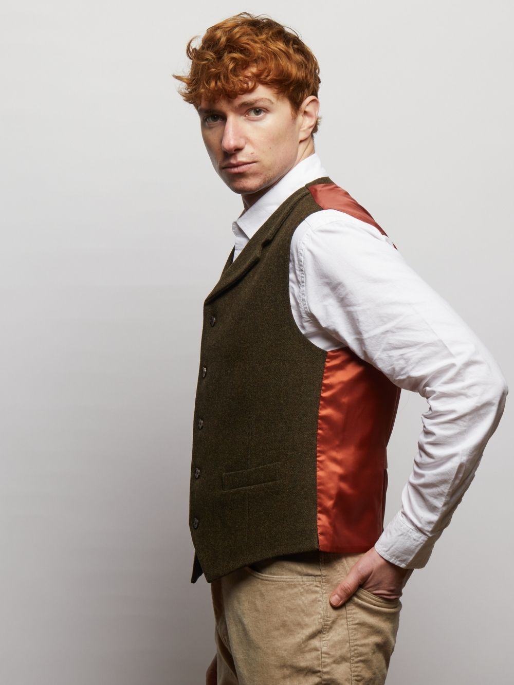 Side view of the Dark Green Herringbone Sherwood waistcoat showing the lined back