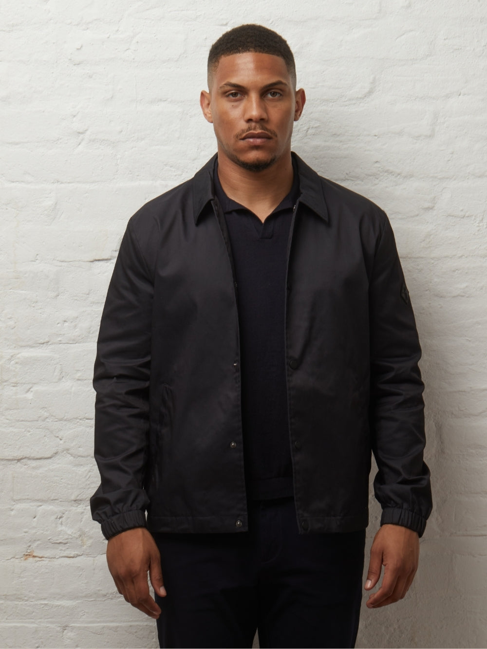 Martello II Black Harrington jacket worn open over a black polo, front view