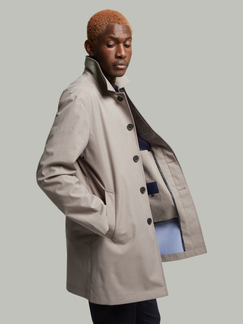 Carver raincoat in Putty worn open on a model, side view showing the contrast lining