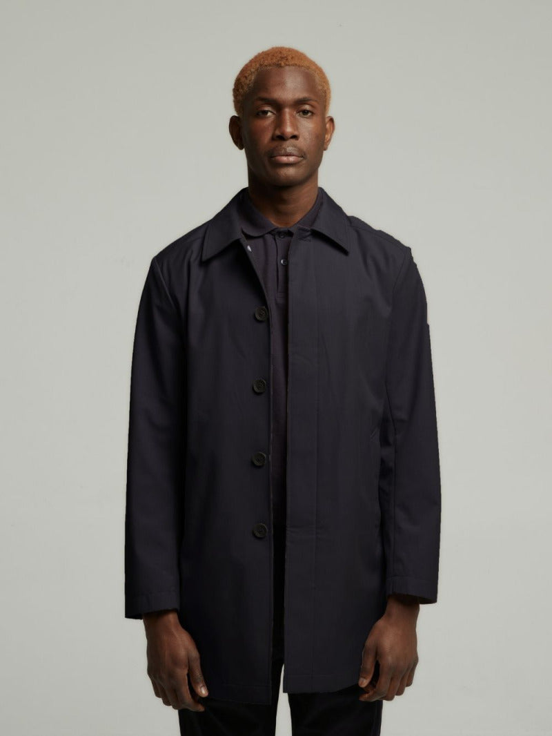 Carver lightweight raincoat in Navy worn fastened on a model, front view