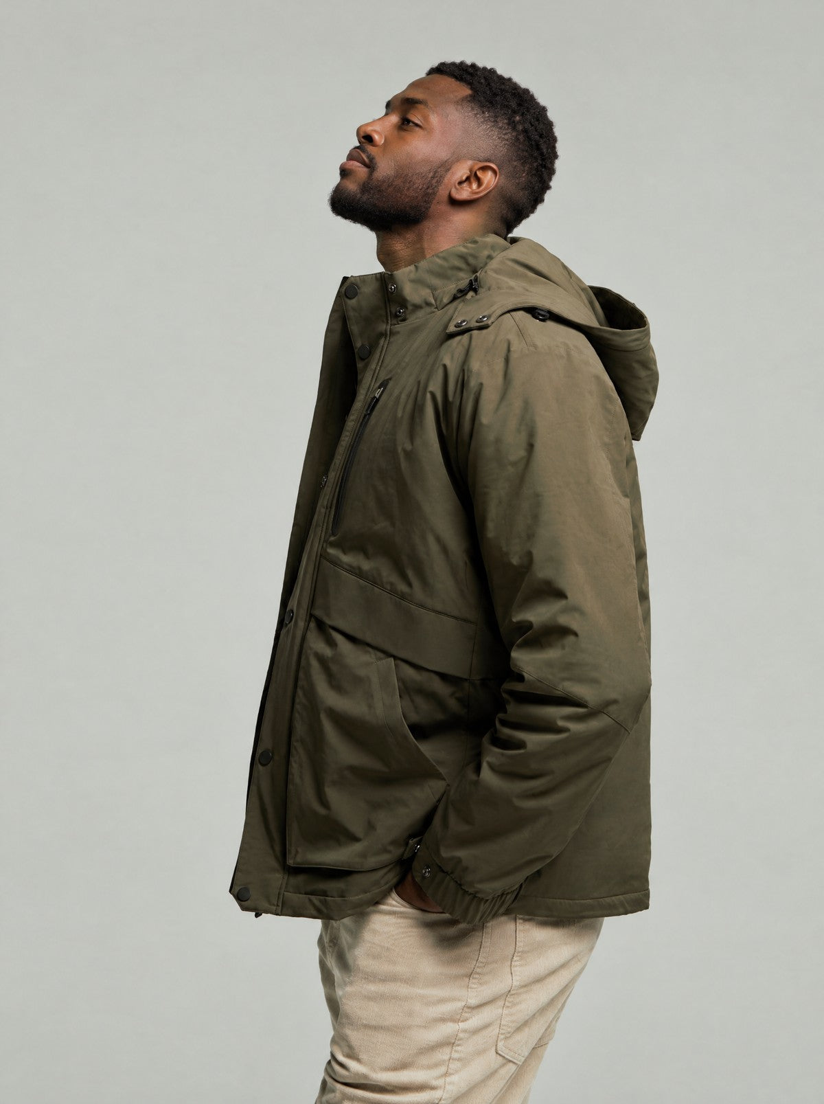 Side profile of the Leighton 3-in-1 parka in Green showing the hood and pockets