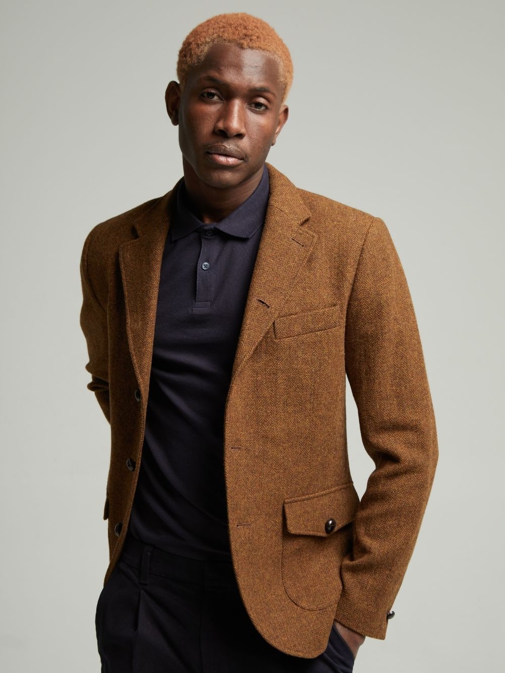 Allenby tweed blazer in Brown worn open on a model, front view showing flap patch pockets