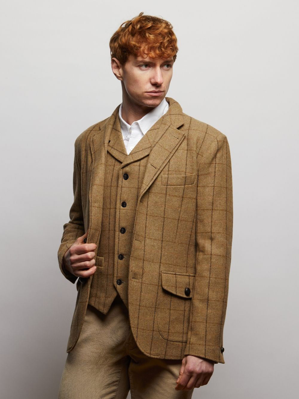 Tan Windowpane Sherwood waistcoat worn under a matching tweed jacket