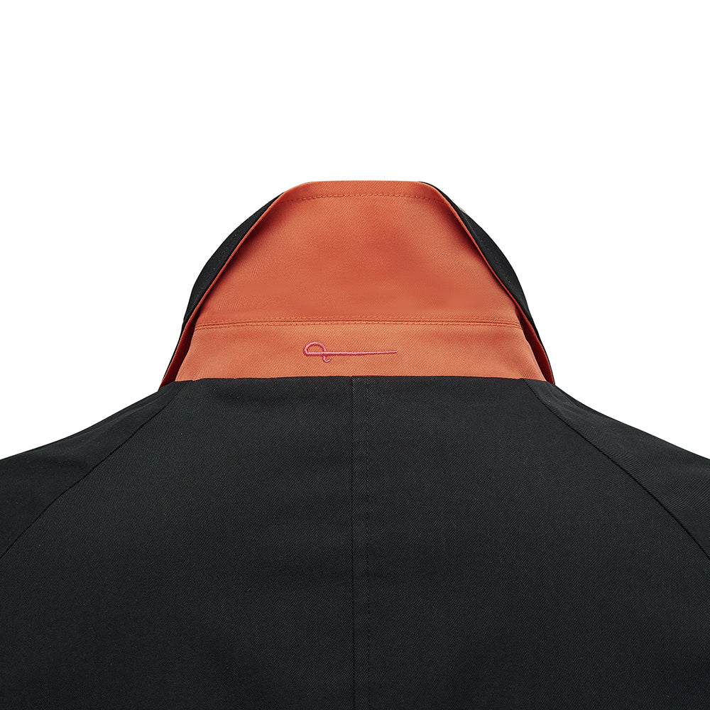 Close-up of the Fusilier Reversible Jacket collar, black side with orange undercollar
