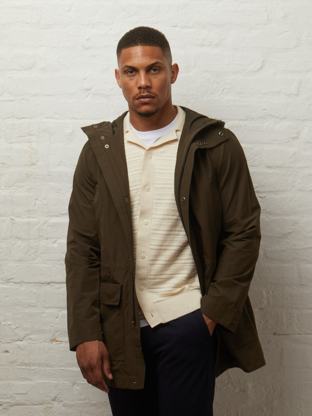 Guards London Blake Lightweight Showerproof Parka in Khaki worn open on a model over a cream knit