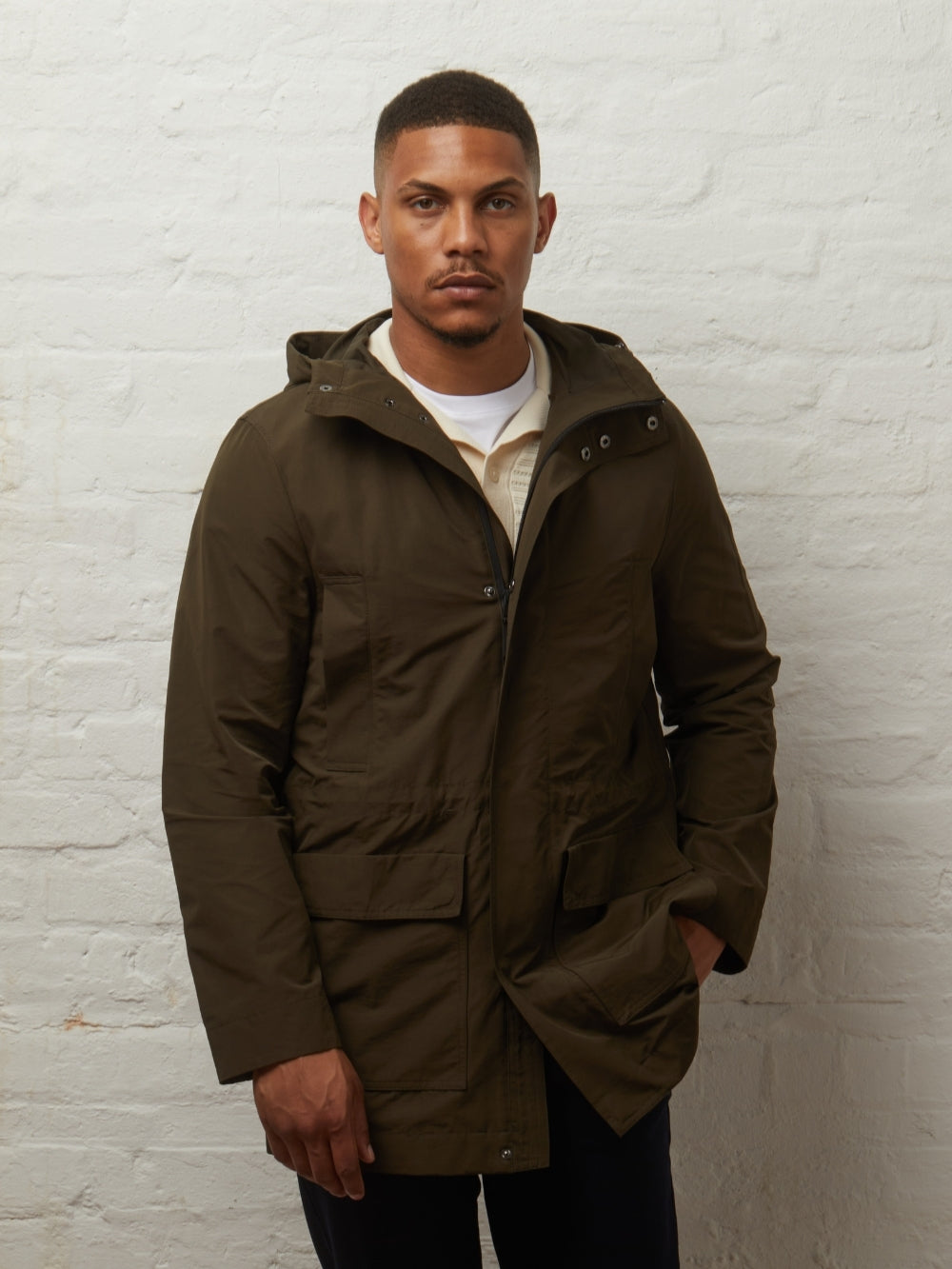 Blake parka in Khaki worn fastened on a model, front view with flap pockets