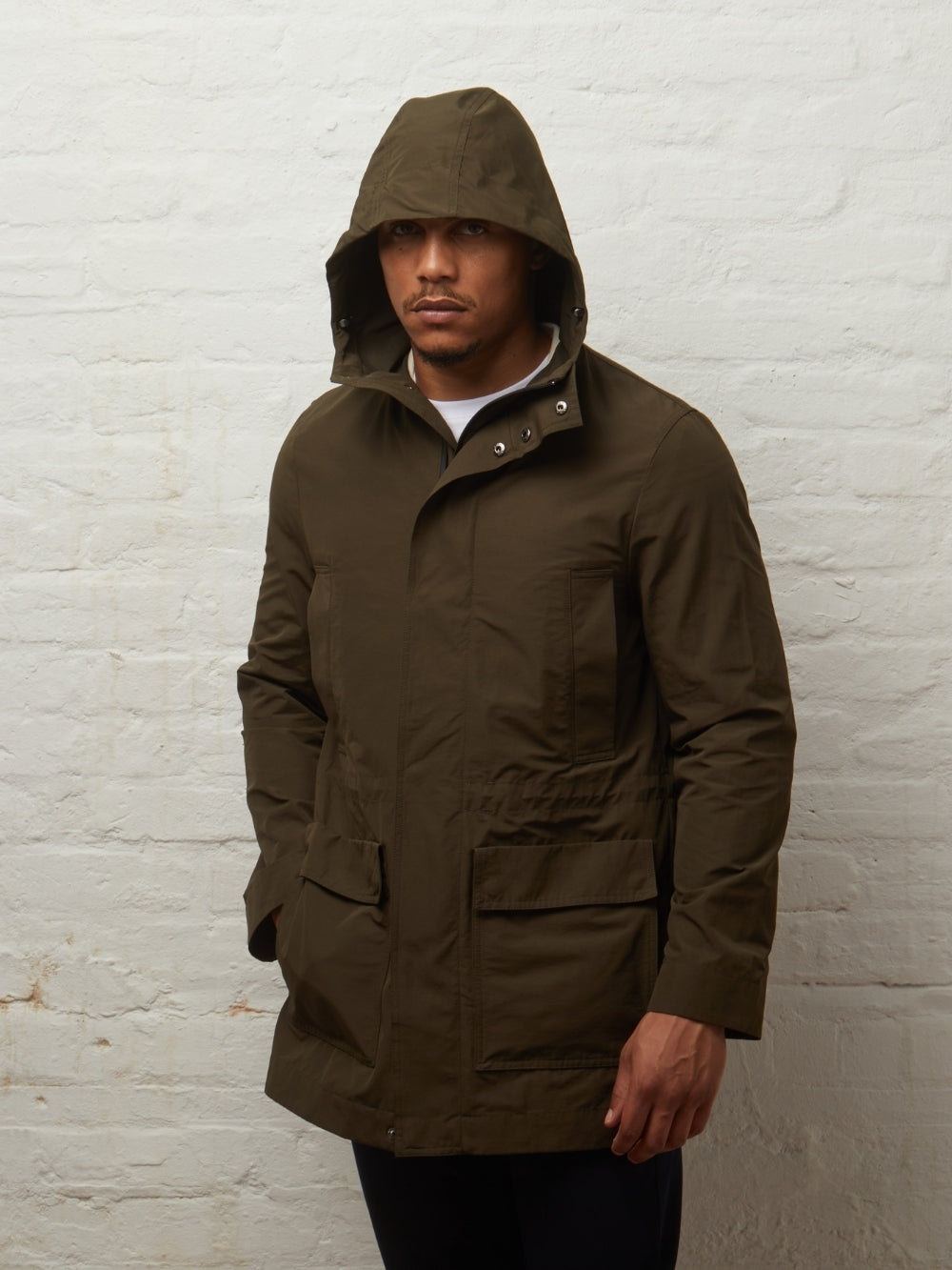 Blake showerproof parka in Khaki on a model with the hood up