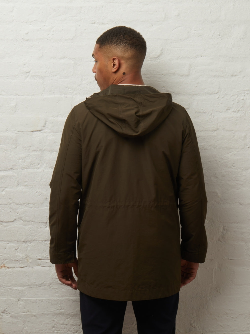 Back view of the Blake parka in Khaki on a model, hood down