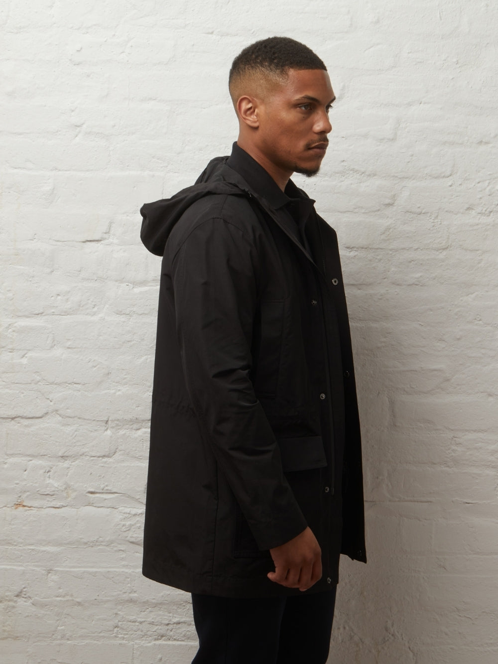 Side view of the Blake parka in Black on a model