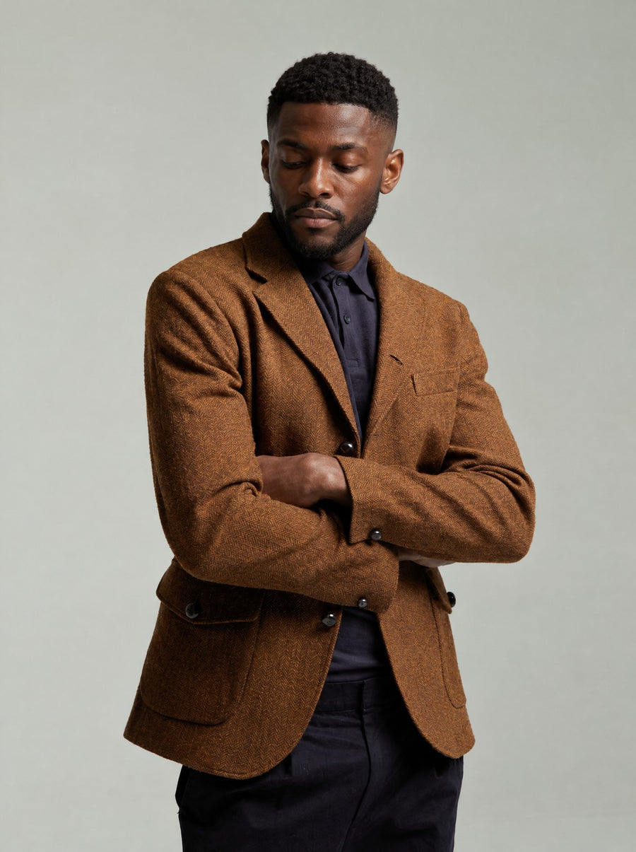 Guards London Allenby Wool Tweed Blazer in Brown worn on a model with a navy polo, arms folded