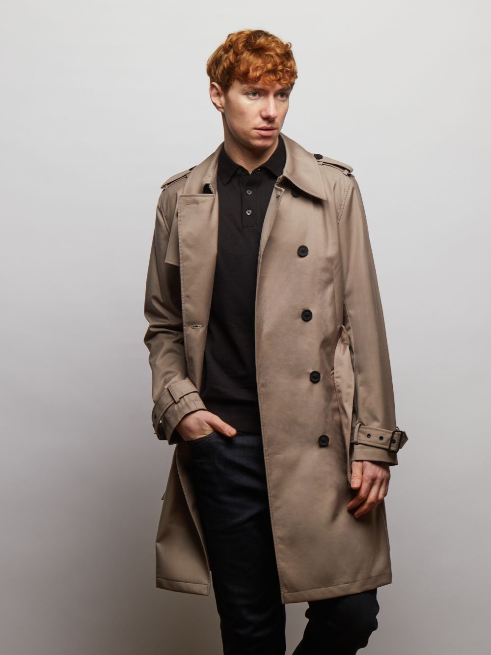 Beacon double-breasted trench coat in Putty worn open on a model over a black polo