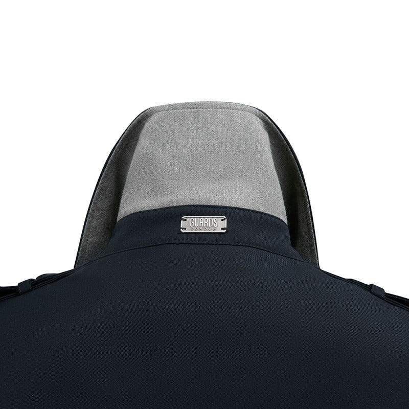 Close-up of the grey undercollar and metal badge on the Beacon trench coat in Navy