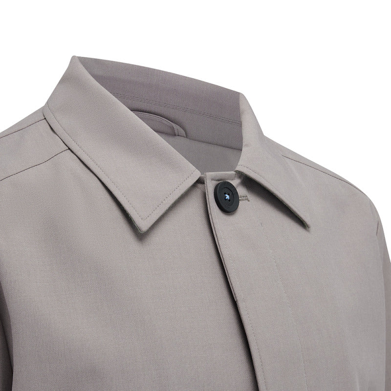 Close-up of the point collar and top button on the Carver raincoat in Putty