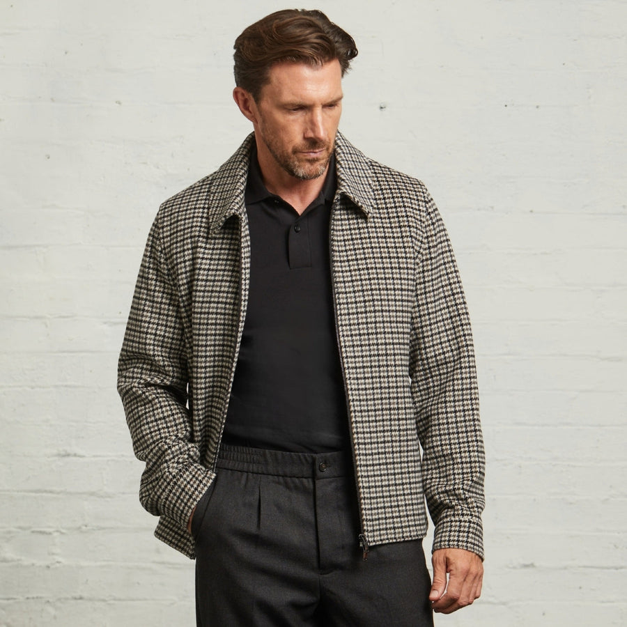 Guards London Edward Wool Check Harrington in Grey worn open on a model over a black polo