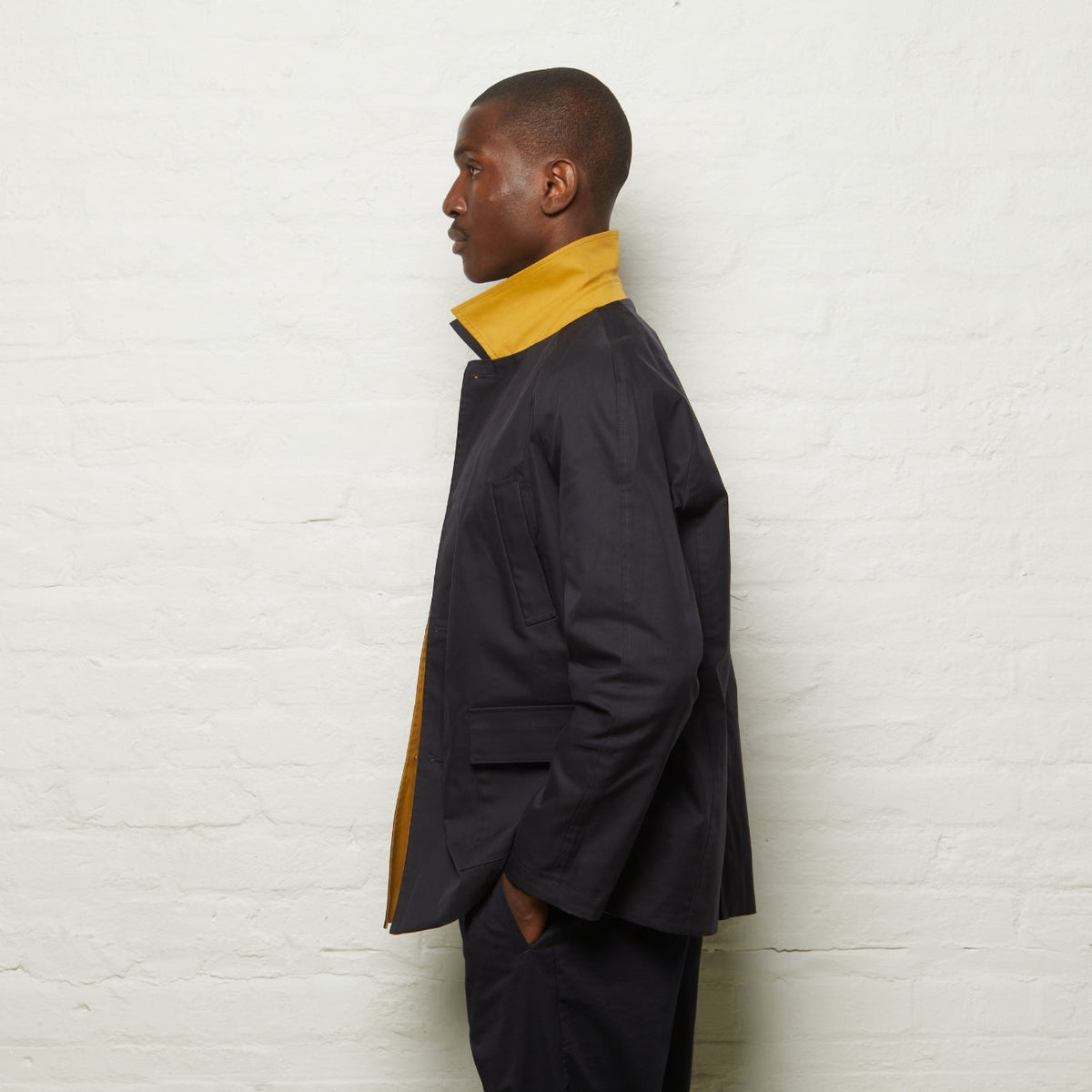 Fusilier Reversible Jacket in Gold/Navy, navy side out, side view with the gold collar turned up
