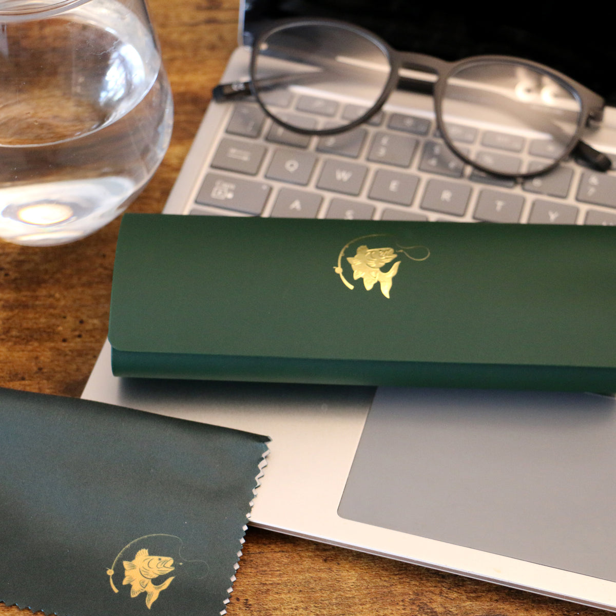 Green Fish & Reel Gold Embossed Glasses Case & Cloth - Leonard Silver - case and matching cloth on a desk