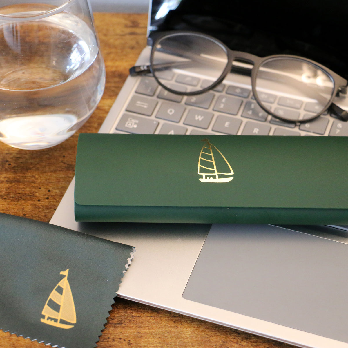 Green Yacht Gold Embossed Glasses Case and Cloth - Leonard Silver - case and matching cloth on a desk
