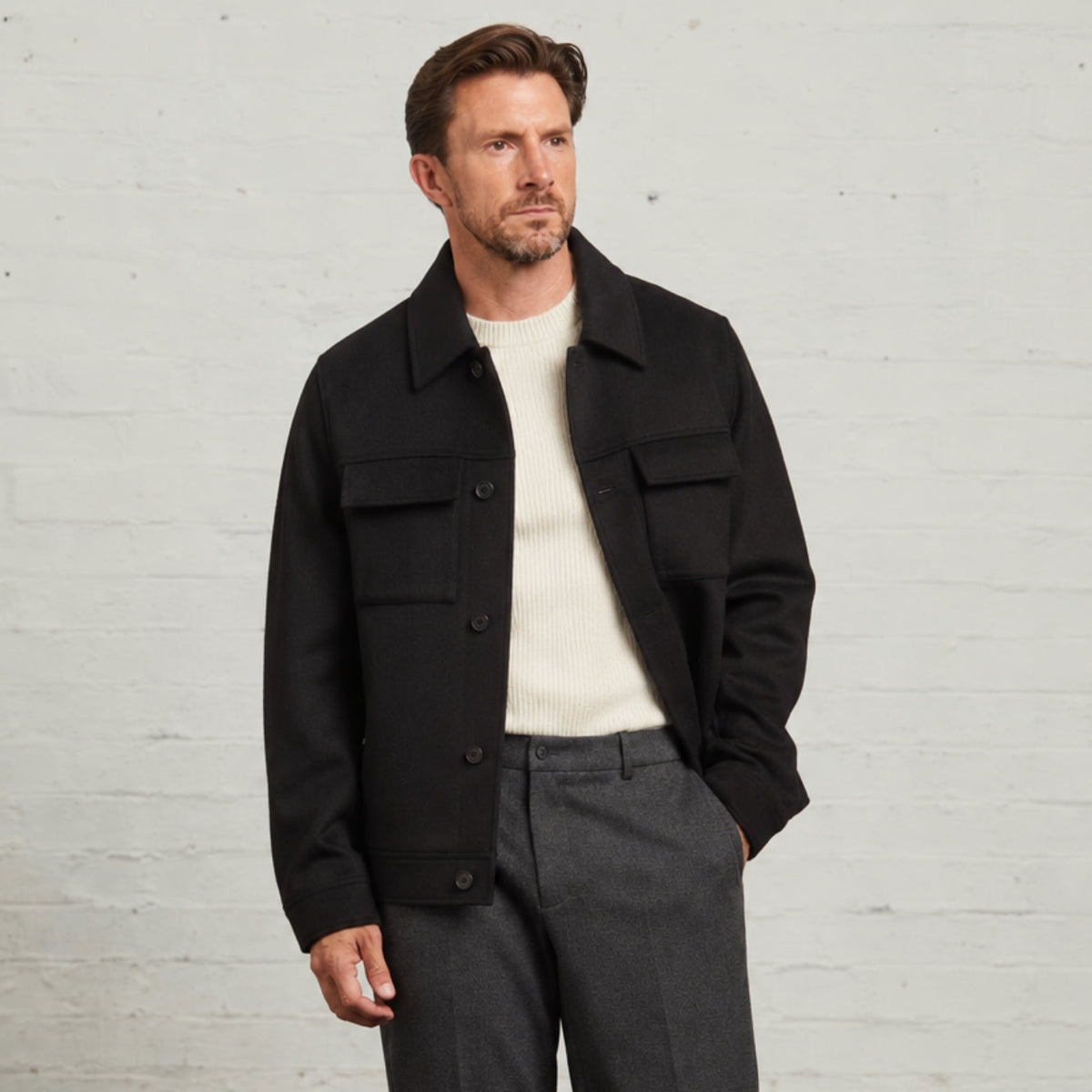 James Wool Short Jacket in Black worn open over a cream knit, front view
