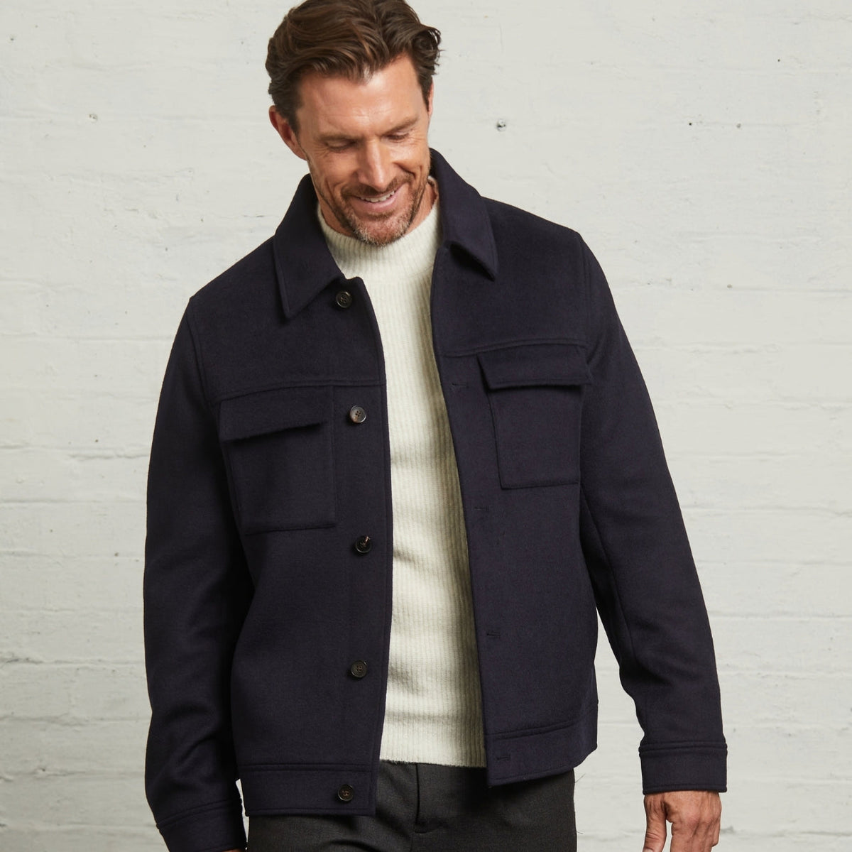 Guards London James Wool Short Jacket in Navy worn open over a cream knit, front view