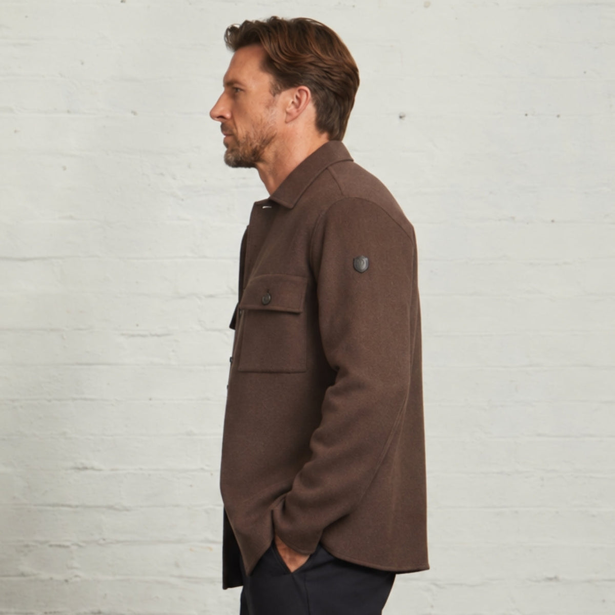 Side profile of the Chocolate Oliver overshirt showing the sleeve badge