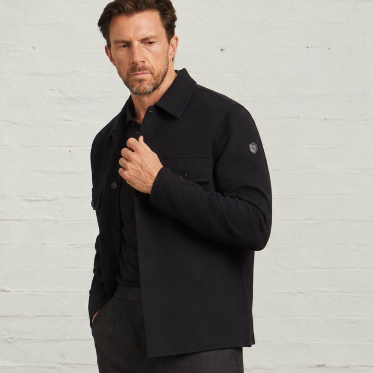 Navy Oliver overshirt, three-quarter view showing the sleeve badge