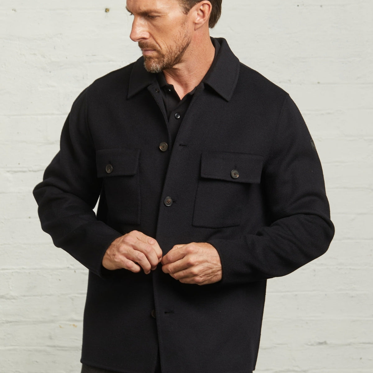 Close-up of the Navy Oliver overshirt chest pockets and buttons