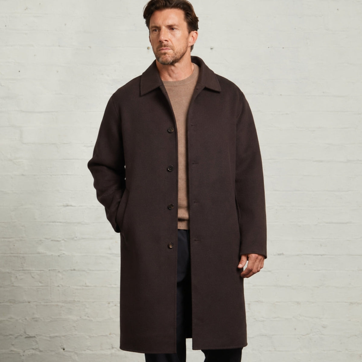 Chocolate Oscar wool overcoat worn open over a camel crew neck