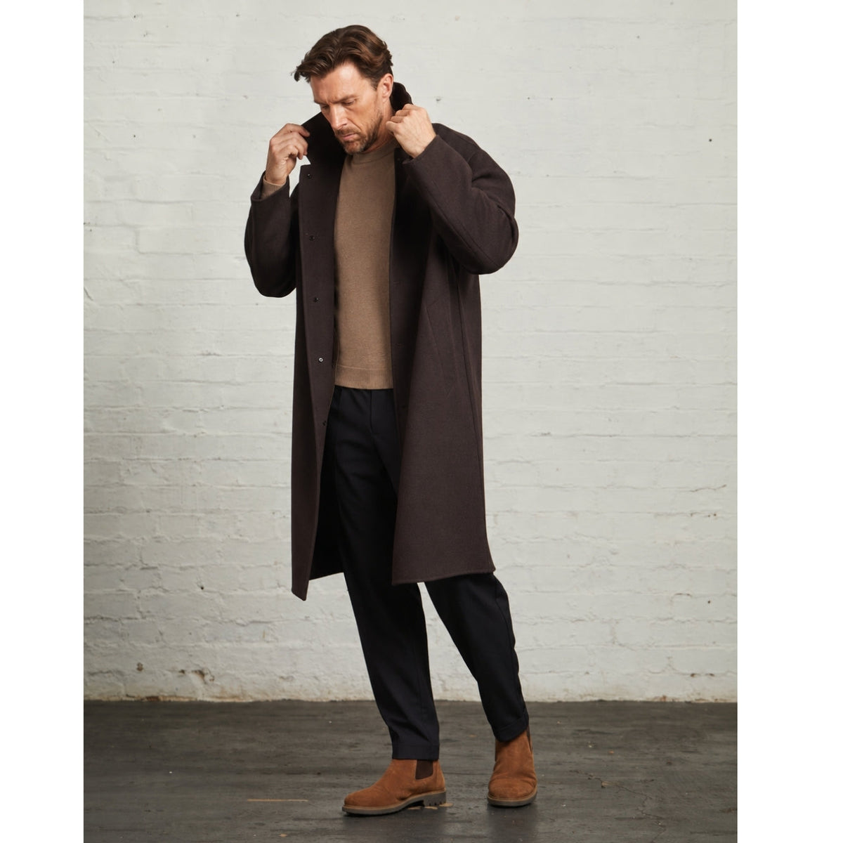 Model turning up the collar of the Chocolate Oscar overcoat
