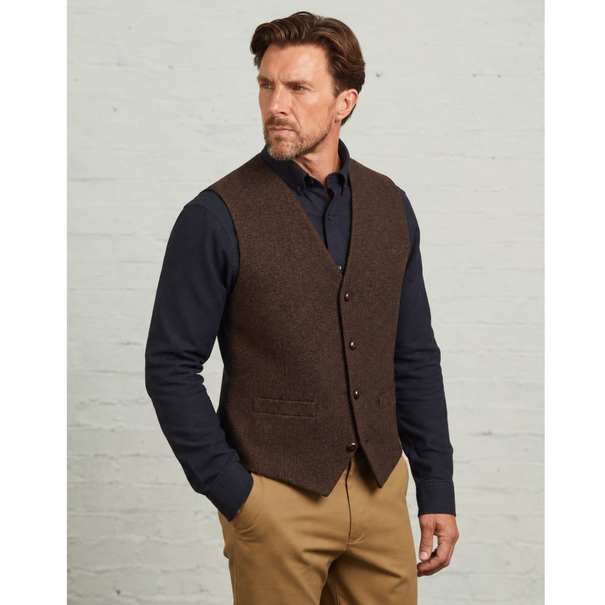 Robert wool waistcoat in Brown, worn over a navy shirt with chinos
