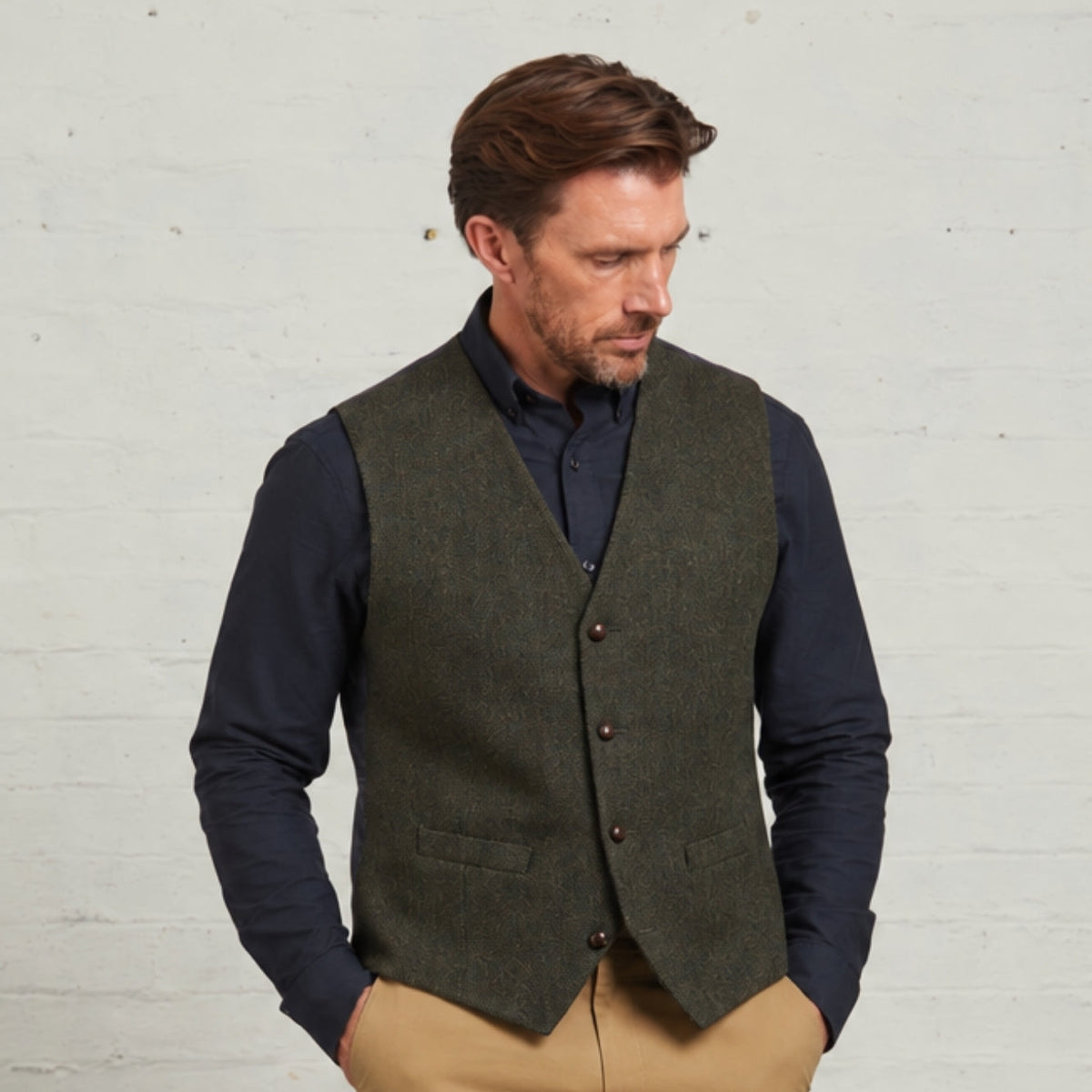 Guards London Robert tweed waistcoat in Green, worn over a navy shirt