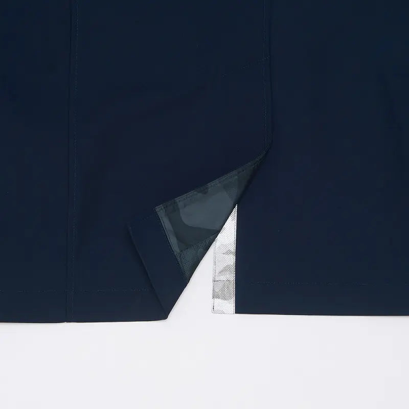 Close-up of the back hem vent on the Navy Wentworth raincoat, lining visible