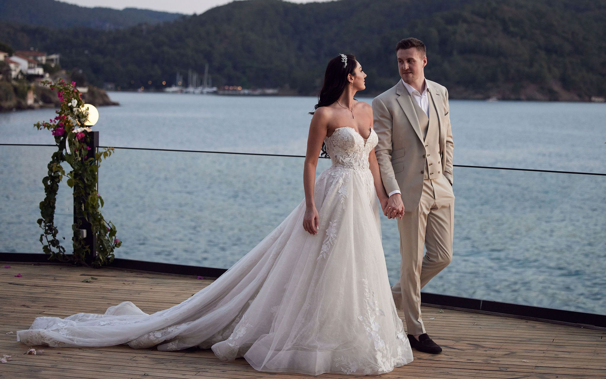 Couple at outdoor wedding, groom in beige bespoke suit — Leonard Silver